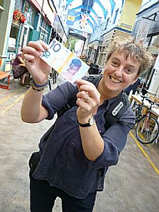 TBI member Catriona Ross spends Brixton local currency at the market.